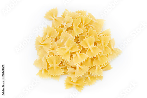 Raw farfalle pasta on white background a lot of dry pieces.