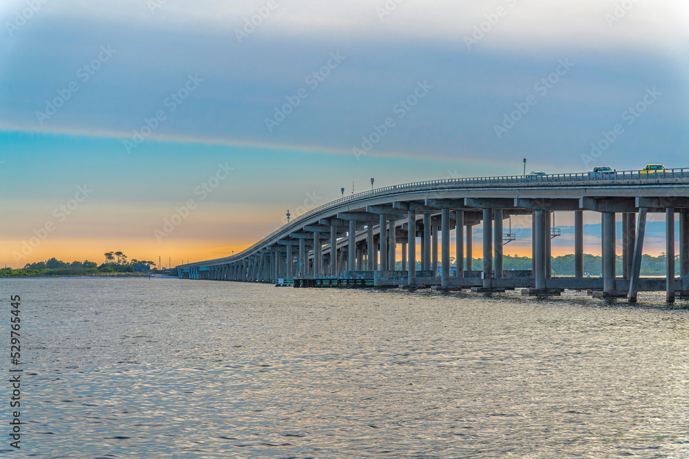 Fototapeta premium Destin Bridge over the sea against the sunset sky at Destin, Florida