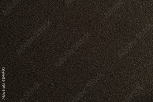 Dark brown natural fine leather background with sunlight and shadow