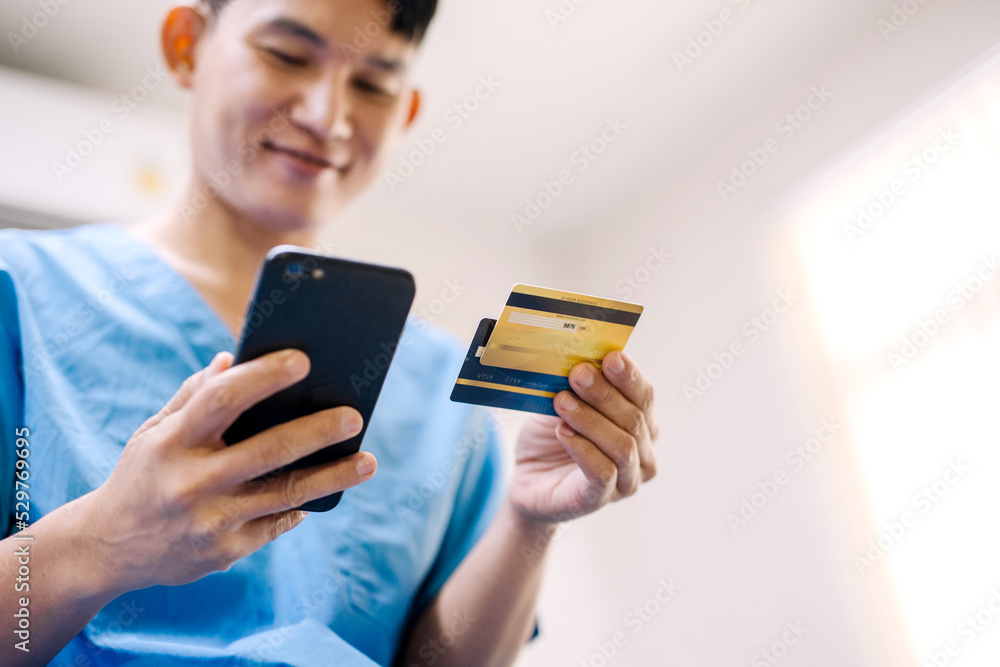 Patient is doing financial transactions by smartphone and credit card mockup. ,Convenience concept of payment with technology Patient is doing financial transactions by smartphone and credit card mockup. ,Convenience concept of payment with technology