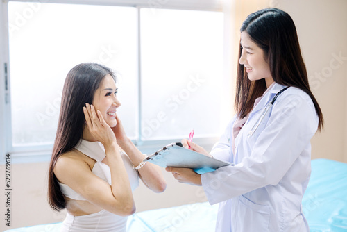 Beautiful Asian woman consulting a cosmetologist for cosmetic surgery in a clinic.