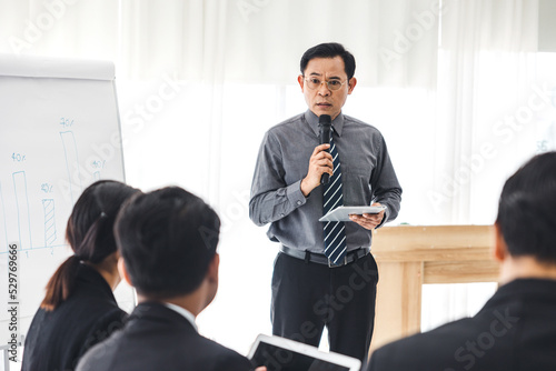 The supervisor is presenting business plans to employees in the company