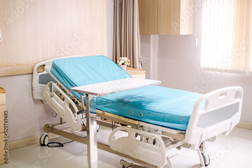 Empty patient emergency bed for wound dressing with curtains in hospital