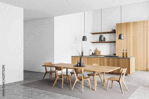 Light kitchen interior with table and seats, cooking and dining area