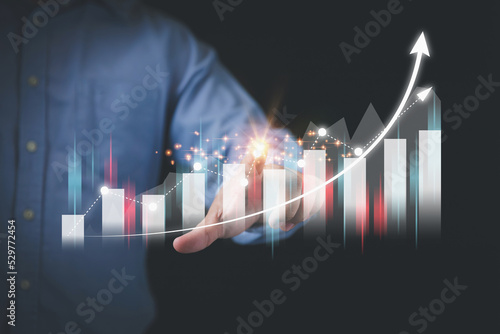 Businessman touching virtual screen growth graph with copy space. Planning strategy, and analyzing marketing for a higher profit for a business. Investment, and financial concepts.