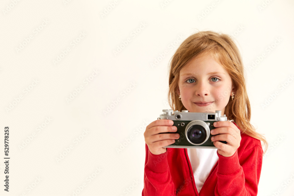 Beautiful smiling child (kid, girl) holding a instant camera Beautiful smiling child (kid, girl) holding a instant camera