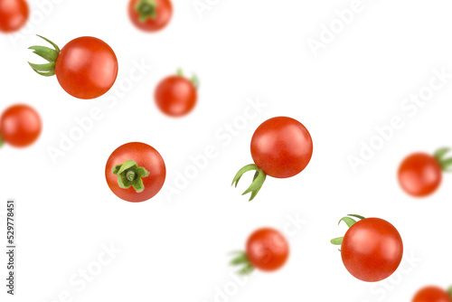 Levitation of ripe cherry tomatoes on a transparent background.