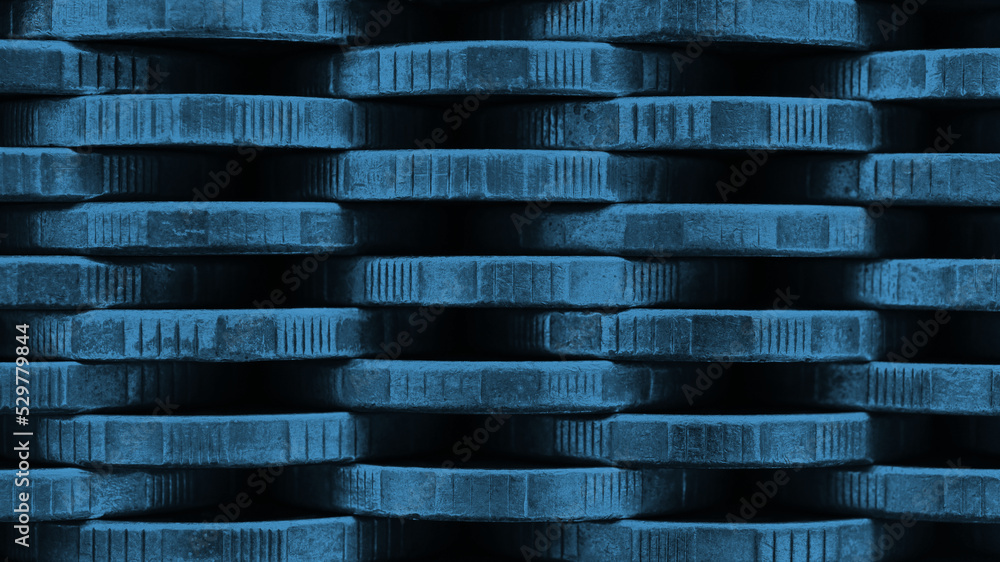 Stack of coins close up. Coin texture. Blue tinted business background made of many coin edges. Economy finance and bank wallpaper. Abstract money wall. Taxes, credit and currency exchange. Macro