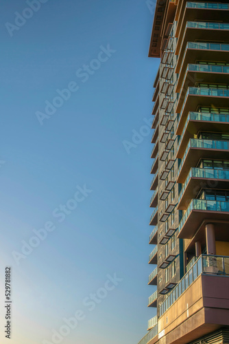 Phoenix, Arizona- Residential building with glass railings on the balconies and window awnings