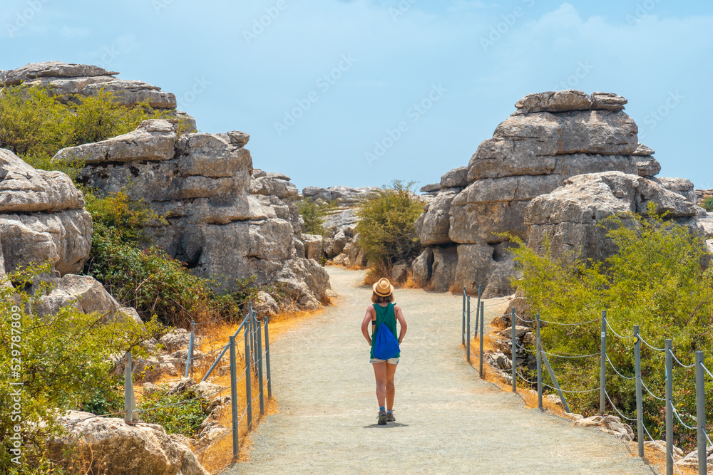 A young woman trekking in the Torcal de Antequera next to the viewpoint, Malaga. Spain