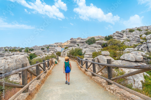 A young woman trekking in the Torcal de Antequera next to the viewpoint in summer, Malaga. Spain
