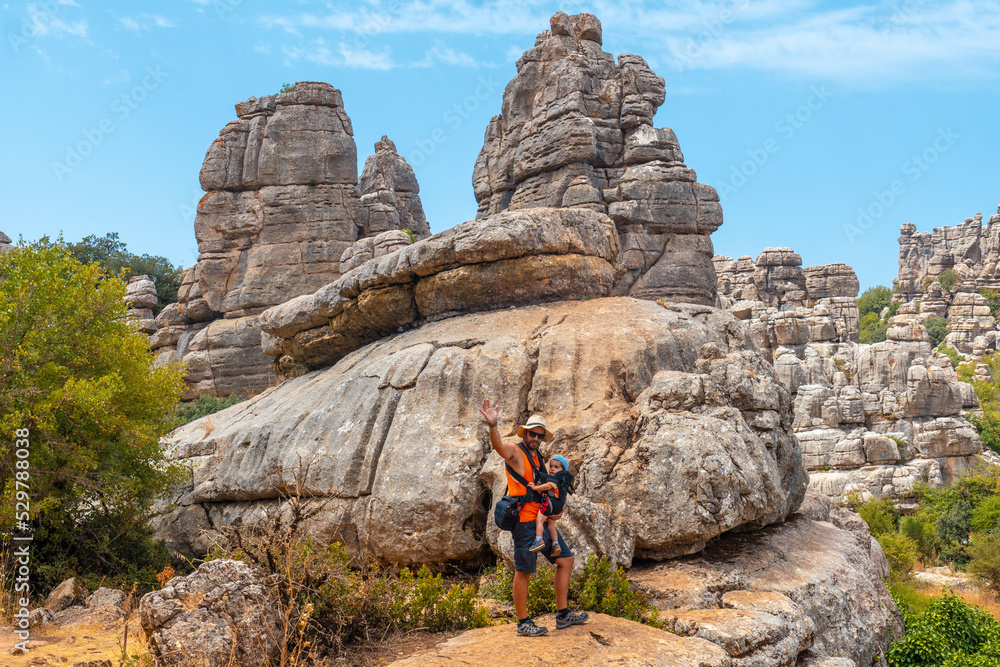 A young father with his son enjoying the Torcal de Antequera on the green and yellow trail, Malaga
