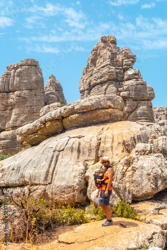 A young father with his son enjoying the Torcal de Antequera on the green and yellow trail, Malaga