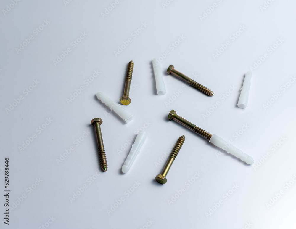 Screw bolt with plastic plugs on isolated white background Screw bolt with plastic plugs on isolated white background