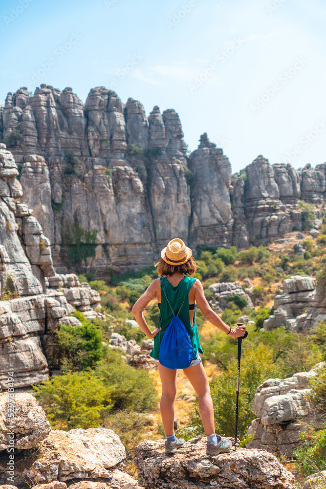 Naklejka premium A young woman in Torcal de Antequera on the green and yellow trail enjoying freedom, Malaga. Andalusia