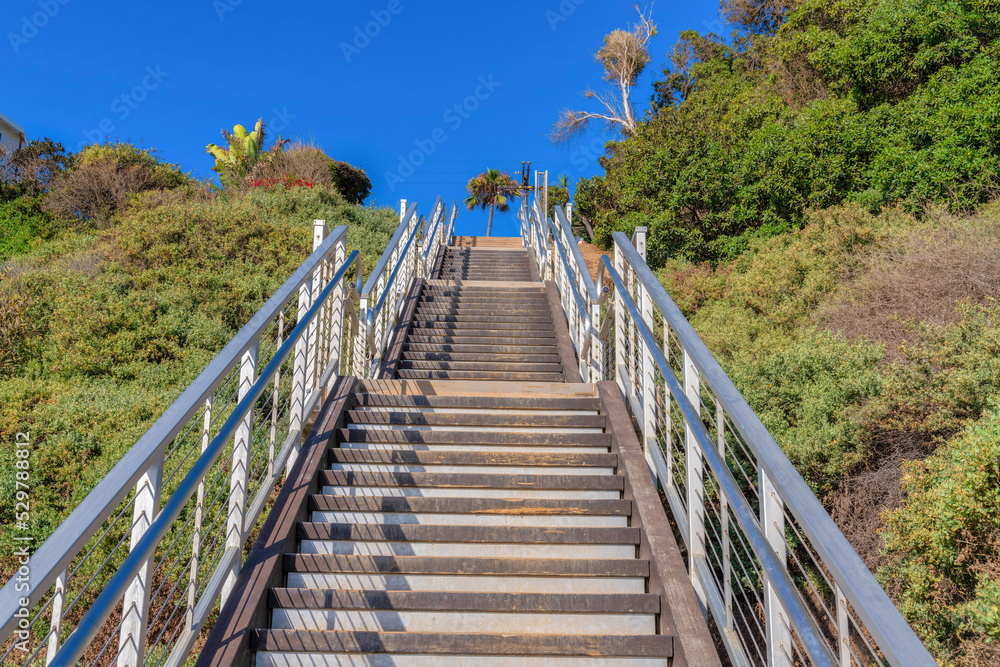 Straight outdoor staircase with metal railings on a mountain slope at San Clemente, California