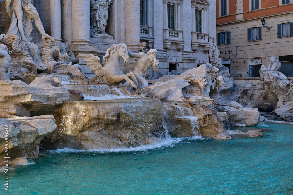 A detail view of the Trevi Fountain in the morning - no people. Tourist attraction in Rome. A detail view of the Trevi Fountain in the morning - no people. Tourist attraction in Rome.