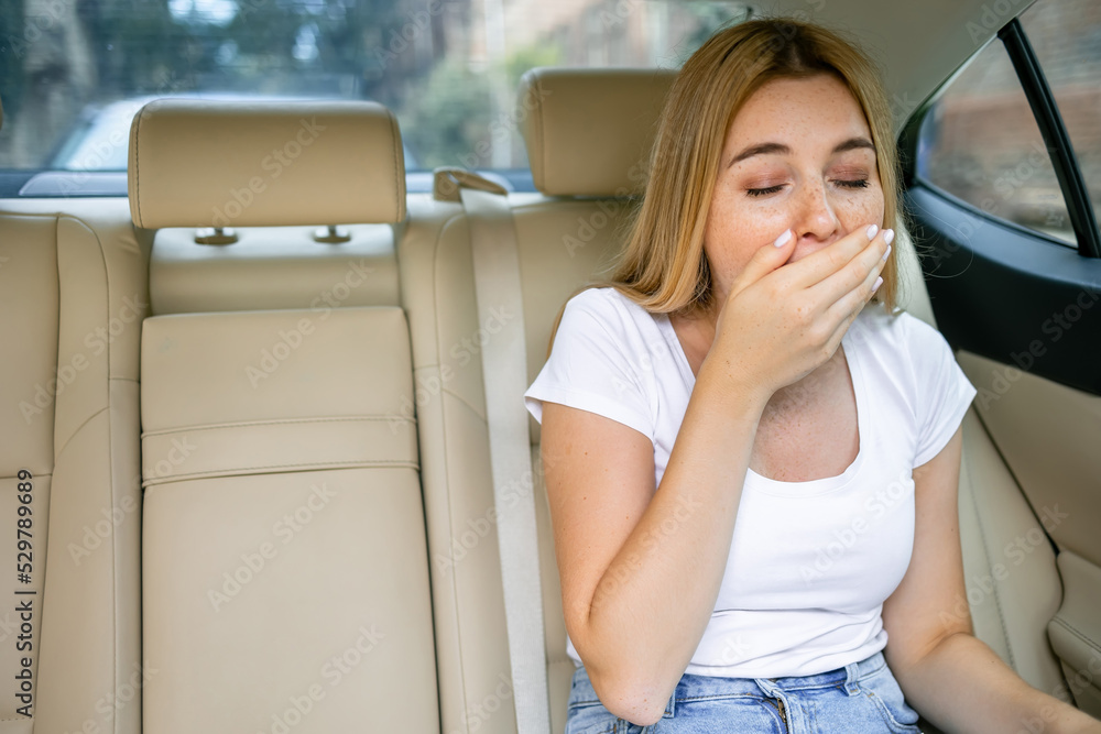 Unhappy  girl who will soon vomit due to car illness or indigestion, woman vomiting in the car, suffering from motion sickness or food poisoning, sad woman feeling  nauseous from motion sickness - obrazy, fototapety, plakaty 
