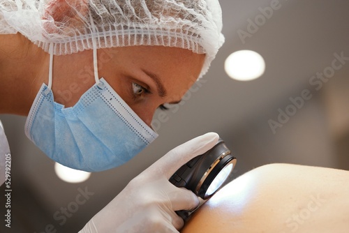 A dermatologist examines the skin.