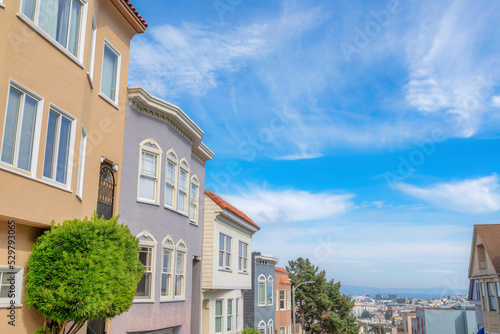 Row of a sloped complex houses with a view of the San Francisco suburbs in California
