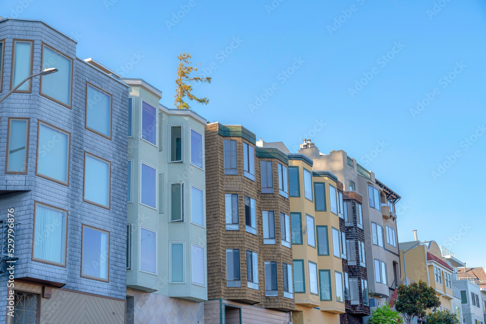 Small apartment buildings with different wall sidings and window