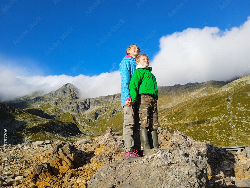 couple of children standing on top  of a mountain for freedom concept