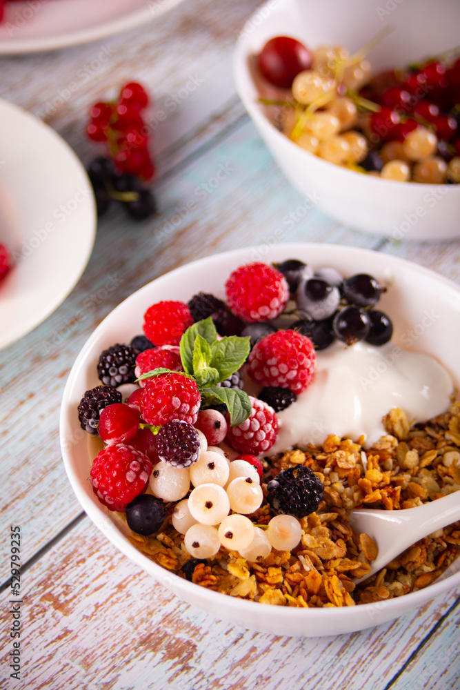 Granola, muesli cereals with yogurt or milk and fresh berries. Healthy breakfast concept. Granola, muesli cereals with yogurt or milk and fresh berries. Healthy breakfast concept.