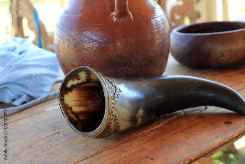 drinking horn on wooden dining table historical reenactment