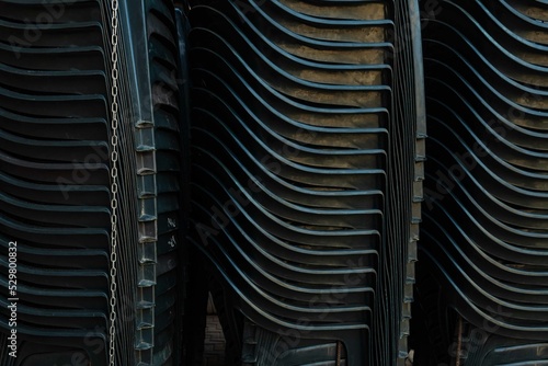 Dark plastic chairs stacked