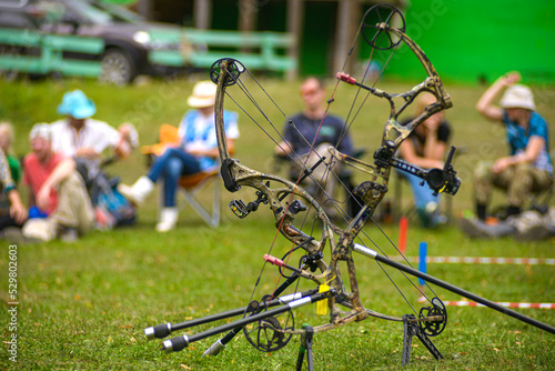 professional archer shooting with modern longbow in forest photo