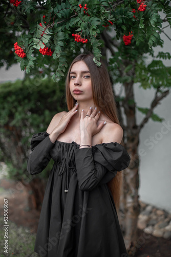 portrait of a beautiful girl on the background of a tree with flowers