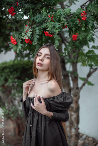 portrait of a beautiful girl on the background of a tree with flowers