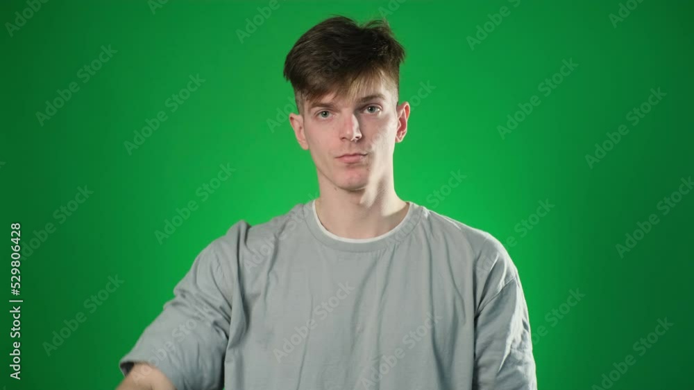 Stop sign by serious young man in gray t-shirt Stop sign by serious young man in gray t-shirt