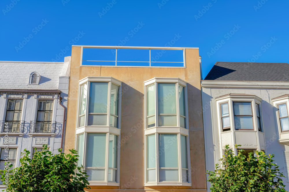 Three adjacent homes with bay windows against the clear sky at San Francisco, California Three adjacent homes with bay windows against the clear sky at San Francisco, California