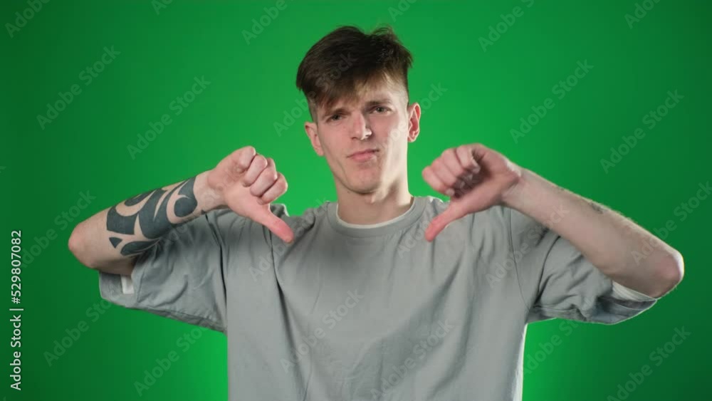 Caucasian man giving thumbs down gesture Caucasian man giving thumbs down gesture