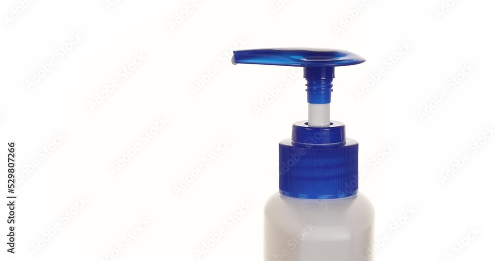 Side view of moisturiser being pumped into a woman's hands. Isolated on a white background. Closeup. Macro. Side view of moisturiser being pumped into a woman's hands. Isolated on a white background. Closeup. Macro.