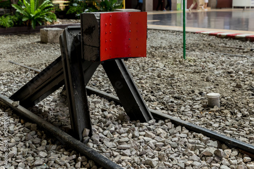 Train stopper or Train bumper installed on track for break. Train stopper for stop train running while parking at railway station at terminus or endways of Railway.  photo