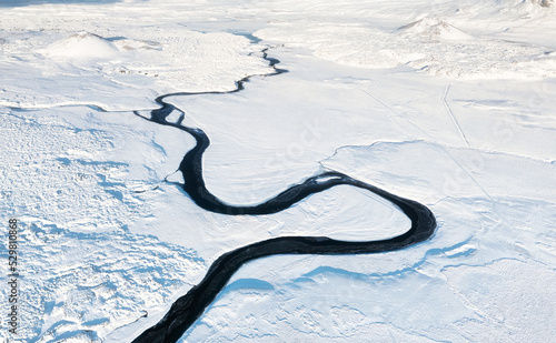 Iceland. Aerial view of the river. Winter landscape from a drone. Traveling along the Golden Ring in Iceland by car.