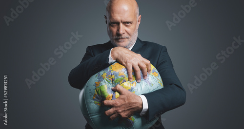Canvas Print Greedy corporate businessman crushing and exploiting earth