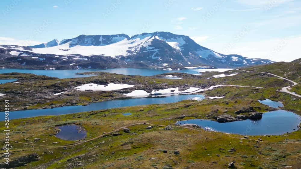Snow patches and lakes in highland, Norway. Drone shot Snow patches and lakes in highland, Norway. Drone shot