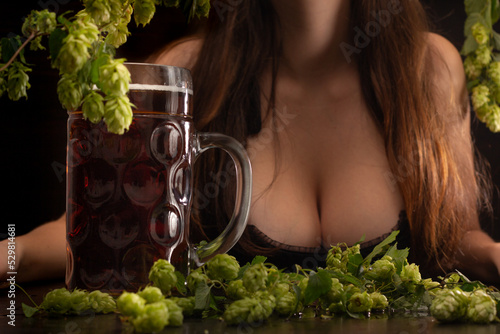 beer with female breast on wooden background in Oktoberfest style