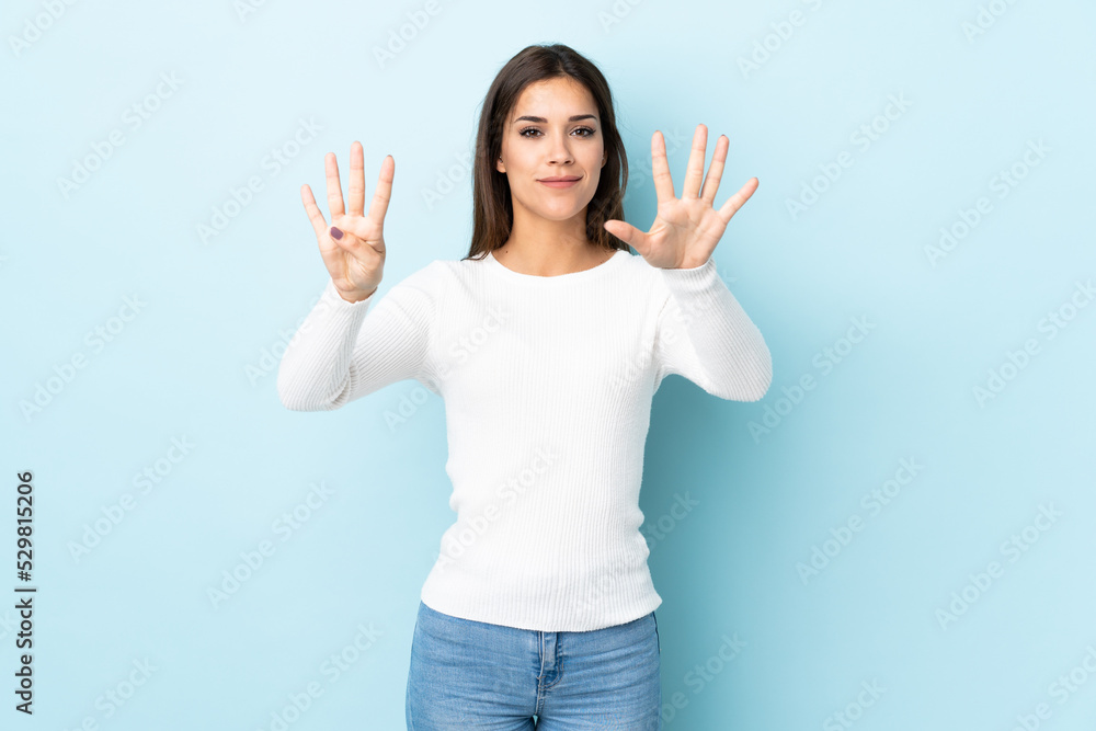 Young caucasian woman isolated on blue background counting nine with fingers Young caucasian woman isolated on blue background counting nine with fingers