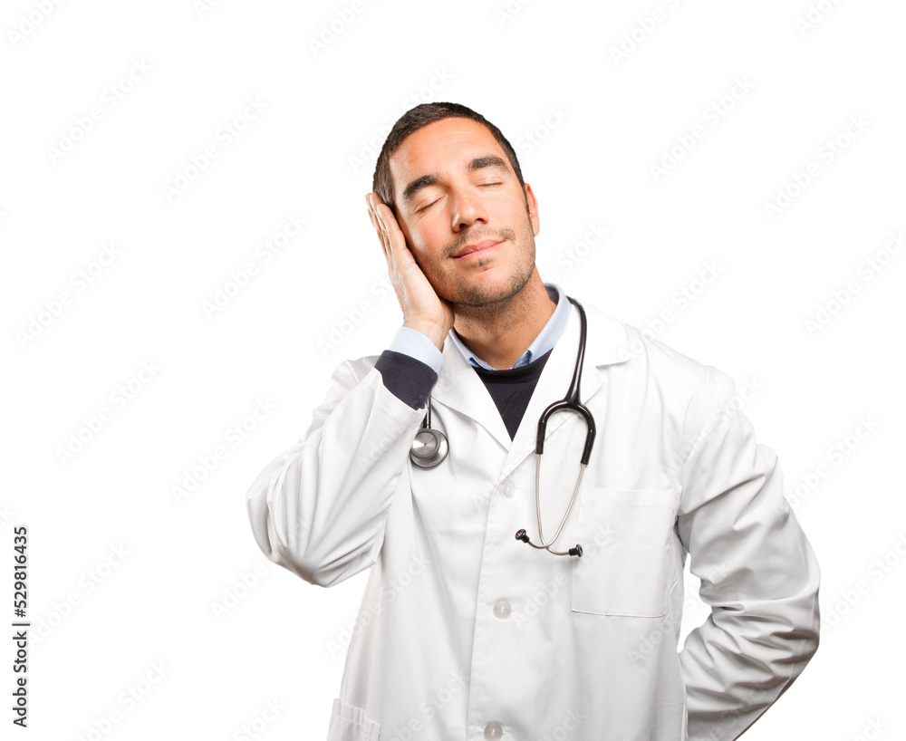 Happy doctor sleeping against white background Happy doctor sleeping against white background
