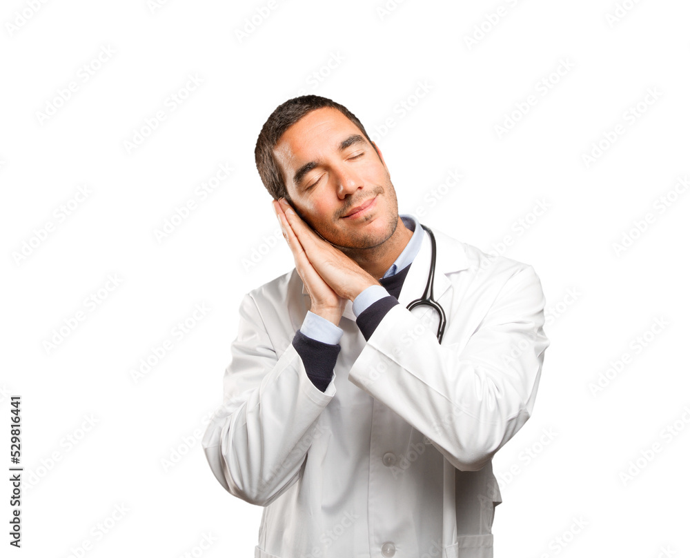 Happy doctor sleeping against white background Happy doctor sleeping against white background