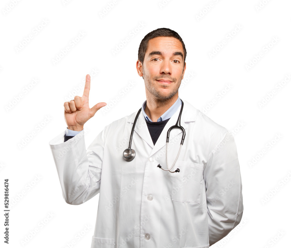 Happy doctor pointing against white background Happy doctor pointing against white background