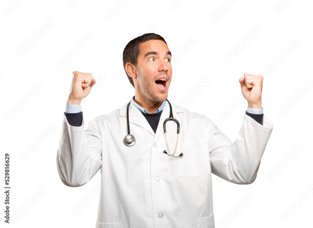 Happy doctor with celebration gesture against white background Happy doctor with celebration gesture against white background