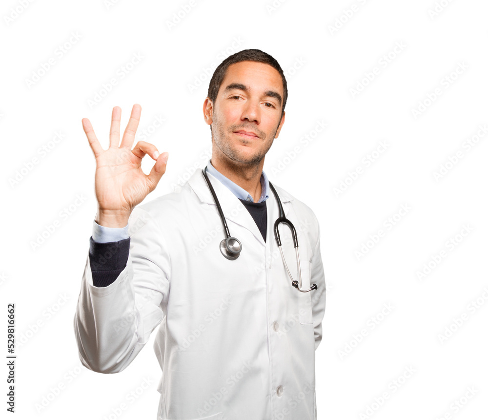 Satisfied doctor with an okay gesture against white background Satisfied doctor with an okay gesture against white background