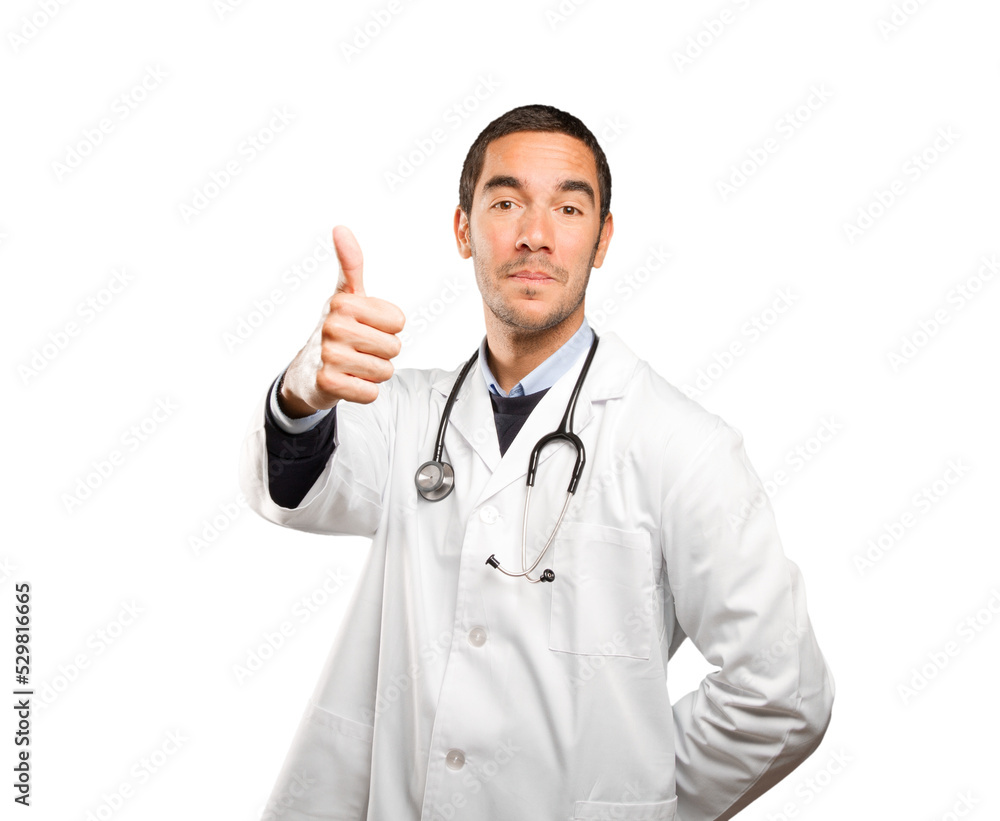 Satisfied doctor with an okay gesture against white background Satisfied doctor with an okay gesture against white background