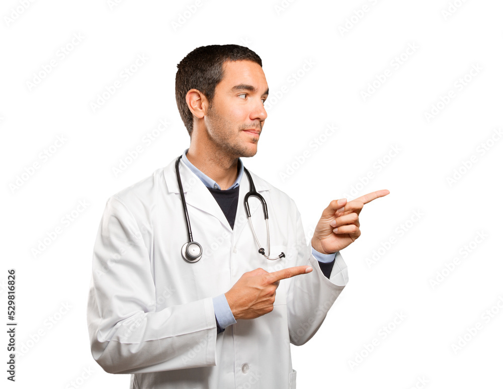 Happy doctor pointing against white background Happy doctor pointing against white background