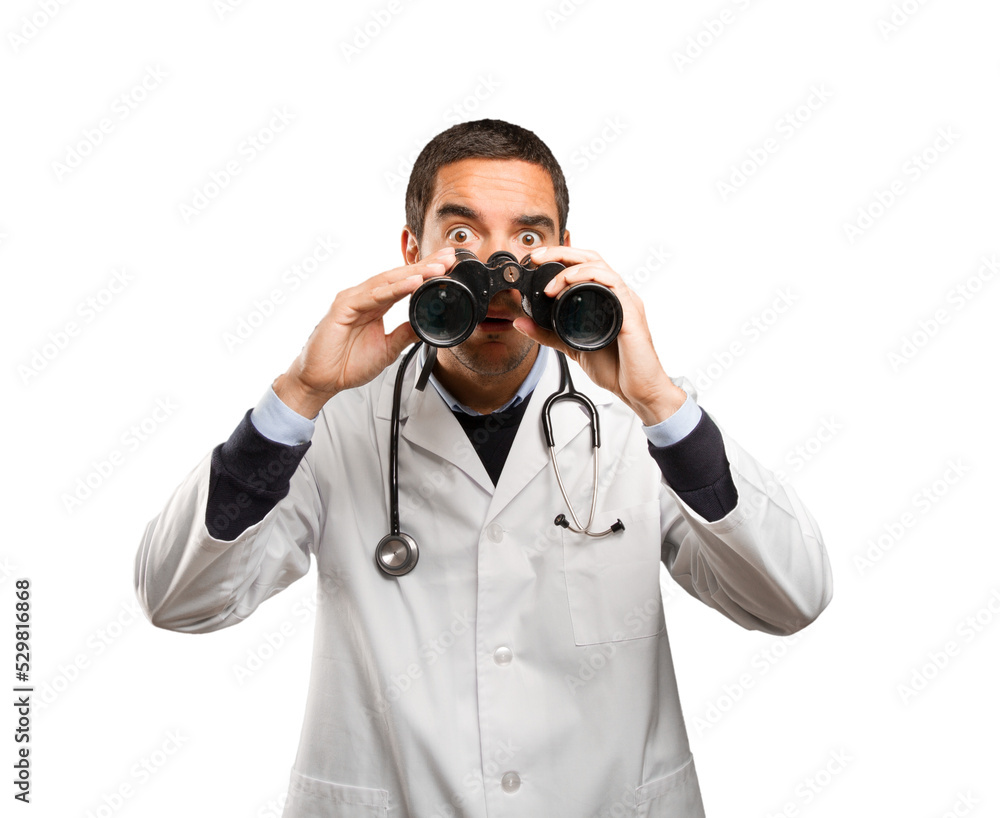 Surprised doctor using a binoculars against white background Surprised doctor using a binoculars against white background